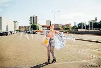 Young woman with eyes closed standing on road