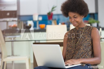 Young woman with laptop working at home