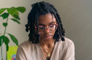 Young woman with locs intentionally making flower infused herbal bath