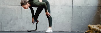 Young woman with prosthesis doing exercise during yoga practice