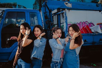 Young Women In Casual Wear Standing In Front Of A Truck