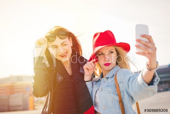 Young women taking selfie on street