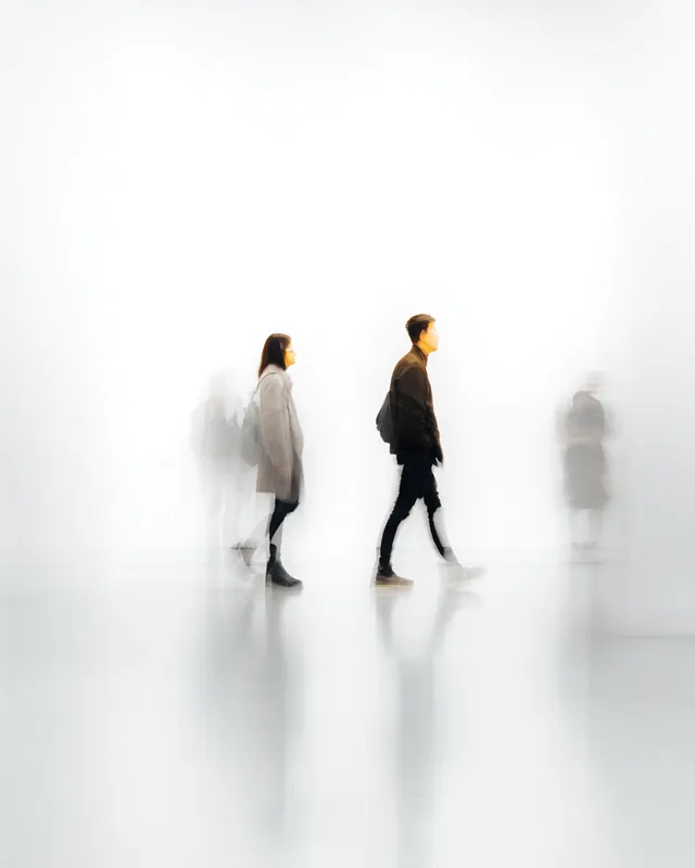 Abstract Motion: Blurred Figures on White Background