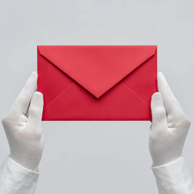 Elegant Hands Holding a Red Envelope