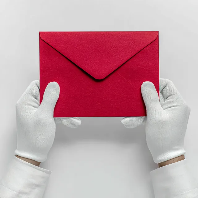 Elegant Red Envelope Held by Gloved Hands