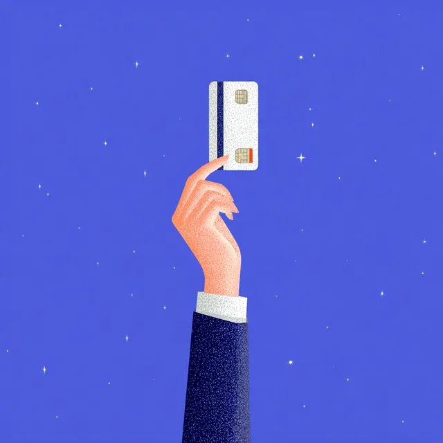 Hand Holding a Credit Card Against a Blue Background