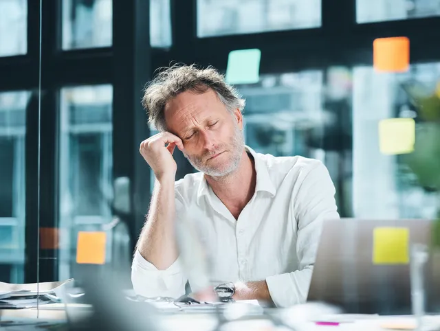 Stressed Professional in a Modern Office
