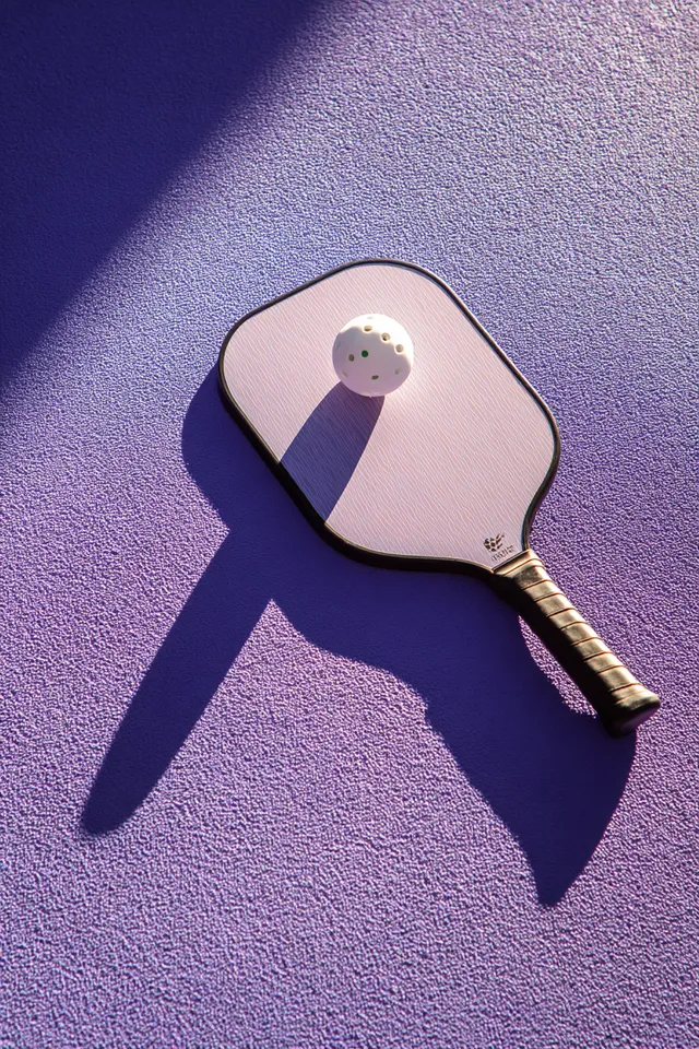Trendy Pickleball Paddle and Ball on Lavender Surface